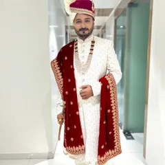 A full-length view of the groom's final look. My work includes ensuring every detail is right, from the makeup and hair to the final styling of the traditional wedding attire.
