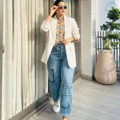 Here is a perfect example of my signature Indo-western fusion. I've paired a traditional Bandhni print top with a crisp white blazer and relaxed cargo jeans. It's a look that feels both professional and uniquely creative.