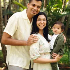 A beautiful family portrait taken outdoors. The natural light and lush greenery create a warm and relaxed setting to capture your family's connection.