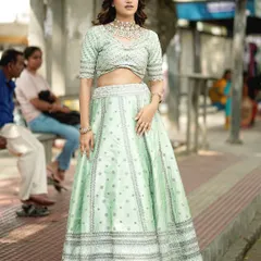 This model is wearing a light mint green lehenga, a wonderful option for a daytime wedding or pre-wedding event. The subtle silver embroidery gives it a fresh and sophisticated feel.