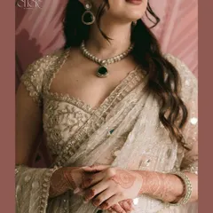 A close-up on the details of the bride's stunning engagement outfit and jewelry. This shot highlights the intricate craftsmanship and the elegance of her bridal look.