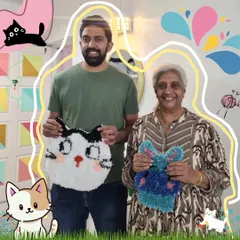 A wonderful multi-generational crafting session. A son and his mother proudly display the cat-themed and abstract rugs they created together.
