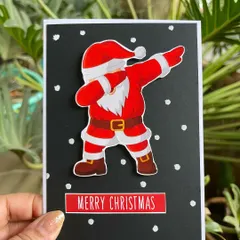 For a fun and modern Christmas greeting, we made this card featuring a dabbing Santa. It's a playful way to send your festive wishes to friends and family.