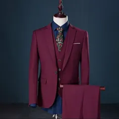 A rich maroon three-piece suit, perfect for a wedding reception or a formal party. The color is deep and the tailoring is sharp.