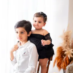 A candid moment between siblings. I love capturing these unposed interactions that show the real relationship between brothers and sisters.