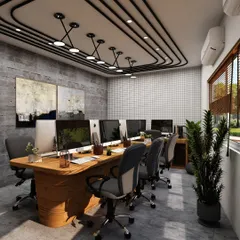 An industrial-chic collaborative workspace featuring a large wooden conference table and unique track lighting on the ceiling. The concrete-finish walls and abstract art add a creative, urban edge to the office environment.