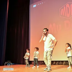 On stage with my students, guiding them during their performance. I am always there to support and cheer them on.