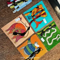 A little behind-the-scenes look at the Gond art project. Here, I was planning the embroidery with my mom, laying out the threads to match the colors in each painting.