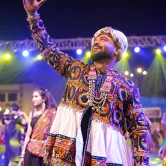 Arms raised, soaking in the energy of the massive crowd at a Navratri night. These are the moments I live for.
