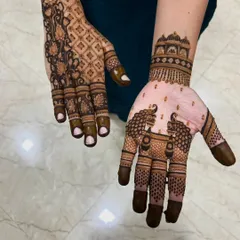 Here you can see two different styles side-by-side. One hand has a traditional peacock design, while the other has a modern floral and lattice pattern, showing the variety we offer.