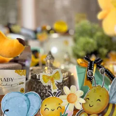 Sweet as honey, bright as sunshine. This close-up shows the adorable bee-themed cutouts and decorations that brought this luxury baby shower hamper to life.
