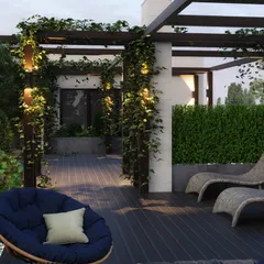 This section of the terrace is designed for pure relaxation, featuring comfortable lounge chairs and a cozy papasan chair. The space is surrounded by lush greenery, including hedges for privacy and potted plants, creating a garden-like feel.