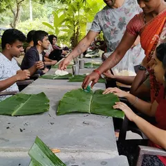 Sharing a meal on banana leaves at a farm retreat, this photo shows the simple, communal moments that make these events so special.