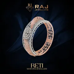 A classic bangle mounting that combines intricate filigree with a solid band structure. The central portion is designed to hold a cluster of stones, creating a timeless piece that balances delicate detail with bold presence.