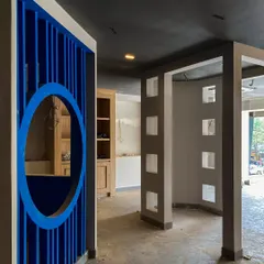 This behind-the-scenes shot shows the structural framework of an experience center coming to life. The bold blue partition with a circular cutout and the geometric column details are foundational elements of the immersive customer journey we are building.
