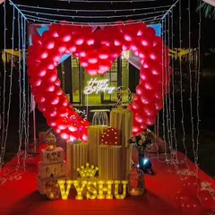 Our signature romantic cabana is perfect for an unforgettable surprise. It features a canopy of fairy lights, a red carpet walkway, and a stunning heart-shaped arch made of red balloons.