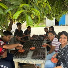 Our workshops are all about getting your hands dirty. Here, we are guiding students through the process of sowing seeds, the very first step in their journey to becoming urban farmers.