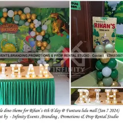 A simple yet fun dinosaur theme for a 4th birthday at Funtura Lulu Mall. The setup includes a jungle-themed backdrop with a balloon garland, a table with a green skirt, and marquee letters spelling out the birthday boy's name.