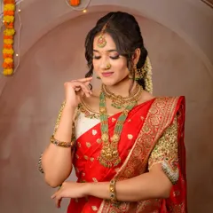 A closer look at the beautiful temple jewelry paired with my red silk rental saree. The heavily embroidered blouse adds to the richness of the overall look.