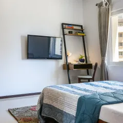 In this bedroom, a compact ladder desk provides a functional workspace without compromising on style. The combination of wood and metal adds an industrial-chic touch that complements the room's earthy and urban aesthetic.