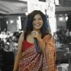 A candid, black and white shot of our amazing female vocalist, lost in the moment of performance. Her energy is truly captivating.