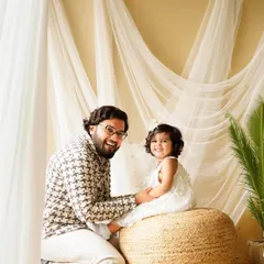 The bond between a father and his daughter is so special. This candid shot captures a moment of shared laughter and joy during their family studio session.