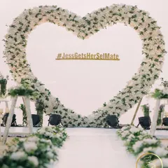 A beautiful heart-shaped floral arch, creating the perfect romantic backdrop for a modern wedding or reception.
