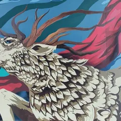 Detail shot of the mythical deer from the Cuppa mural. The design incorporates intricate, feather like patterns and flowing red fabric to create a sense of motion and majesty.