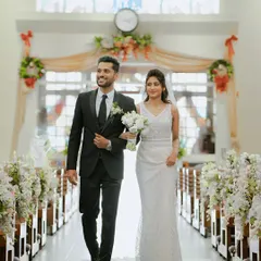 The bride and groom walk down the aisle, united and happy, during their classic church wedding. This demonstrates our experience in capturing the elegance and solemnity of diverse cultural ceremonies.