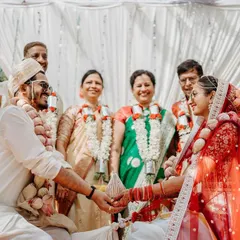 A beautiful moment from a traditional Kannada wedding, where the couple and their parents are all smiles during the ceremony. We capture the joy of families uniting.