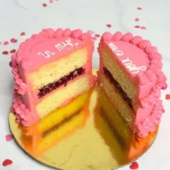 Here's a look inside my mini vintage cake. This is my 3 Berry Victoria flavour, featuring layers of fluffy vanilla sponge and my signature house-made berry compote, all wrapped in pretty pink buttercream. I believe a cake should taste even better than it looks, and this cross-section proves it.