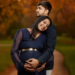 A tender embrace from behind, with both partners cradling the baby bump. This pose emphasizes support, love, and the shared journey of pregnancy.