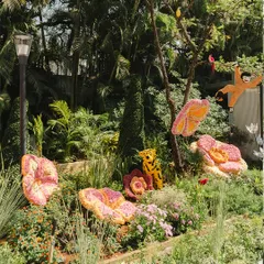 This scene from a garden party shows a variety of my floral sculptures, including a tiger and a flamingo, nestled among natural greenery.