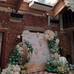A wide view of the 'Adventure Awaits' baby shower decor, showing how we transformed the space with a custom backdrop, balloon art, and themed elements.