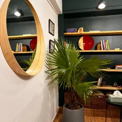 Another view of our studio's decor, showing the clean and organized shelving against a dark, elegant wall.