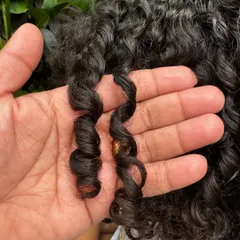 A close-up of this little one's perfectly formed spiral curls. With a gentle routine, kids' hair can be healthy and manageable.