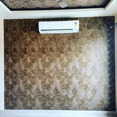 An accent wall created with a bold, geometric pattern wallpaper. I can install any type of wallpaper to make a statement in your room, whether it's for a home or an office.