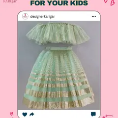 A mint green and gold lehenga for kids. The off-shoulder ruffled top and shimmery skirt are perfect for a little fashionista.