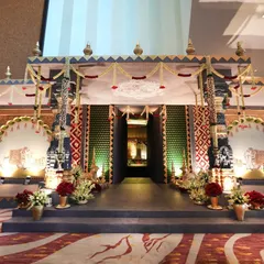 A frontal view of the temple entrance structure, showcasing the symmetrical design and detailed craftsmanship. The illuminated archways and traditional motifs were inspired by the grandeur of South Indian temple architecture.