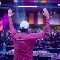 Arms up, connecting with thousands of people. This moment during the Holi festival captures the pure joy and unity that music brings to a massive celebration.