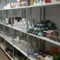 We offer a wide range of neutral-toned ceramic planters, including classic white cylinders and unique, artisanal glazed pots.