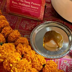 A creative fusion of North Indian and Pan-Asian cuisines: Sarson da Saag Paneer Bao. A soft, steamed bao bun is stuffed with classic mustard greens and cottage cheese, served with a dollop of makhani sauce.