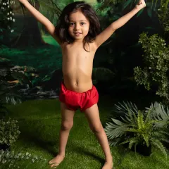 A triumphant pose in the heart of the jungle. These themed shoots are all about capturing your child's powerful imagination and playful spirit.