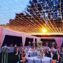 I can transform large outdoor spaces for evening events like this sangeet or reception. Here, I created a canopy of fairy lights over the entire guest seating area to build a magical and festive atmosphere.