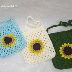 Here you can see the variety of colors available for my sunflower granny square sling bags. This photo shows the design in sky blue, off-white, and forest green.