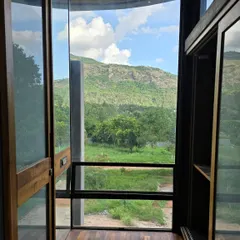The design of Villa Soham is about framing and gathering the landscape. From the walk-in closet, the view is not an afterthought but a primary feature, connecting even the most private moments to the vastness of the hills outside.
