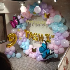 A whimsical butterfly-themed birthday for Tashi. This pastel balloon ring is decorated with beautiful, large butterfly foil balloons and personalized with a name and number, creating an enchanting photo spot.