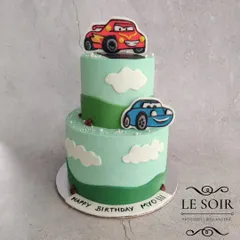 A two-tier cake for a fan of the movie Cars. This 2 kg Chocolate Truffle cake features 2D fondant figures of Lightning McQueen and Sally against a backdrop of rolling green hills.