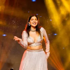 A candid shot of a bride's solo, her smile lighting up the stage. These are the moments we live for.