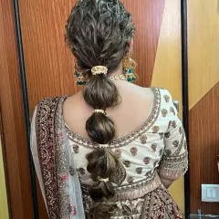 A modern and stylish bubble ponytail. This hairstyle is fun, chic, and perfect for a bride who wants something unique for her pre-wedding functions.